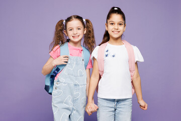 Little smiling happy two friends children school girls 9-10 years old wear casual clothes backpack...
