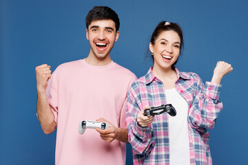 Young couple two friends family man woman they wear pink casual clothes together hold in hand play...