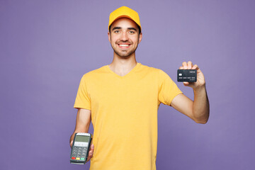 Young delivery guy employee man he wear yellow cap t-shirt uniform workwear work as dealer courier...