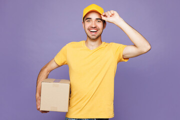 Professional fun delivery guy employee man wear yellow cap t-shirt uniform workwear work as dealer...