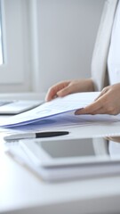 Businesswoman reviewing financial documents and charts, performing data analysis for business...