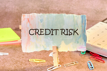 CREDIT RISK analysis and management concept. Words CREDIT RISK on a piece of paper in a clothespin