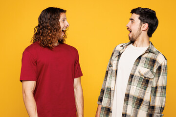 Young shocked surprised two friends buddies men they wearing casual clothes together look to each...