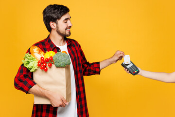 Young man wear casual clothes hold bag for takeaway mock up with food products bank payment...