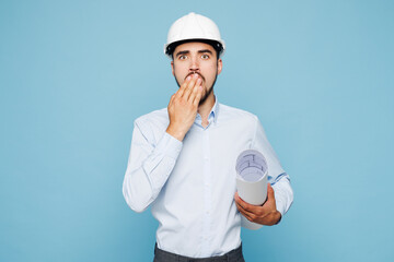 Young architect engineer designer employee man wears white clothes shirt hardhat hold blueprints...