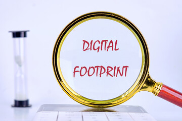 A magnifying glass highlights the term digital footprint, symbolizing its significance in...