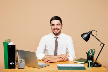 Young smiling happy cheerful successful employee business man he wear white shirt tie sit work at...