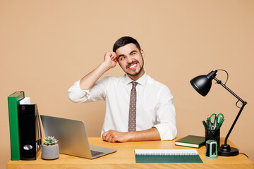 Young sad unhappy employee business man he wear white shirt tie sit work at office desk with pc...