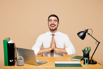 Young fun employee business man wear white shirt tie sit work at office desk with pc laptop hold...