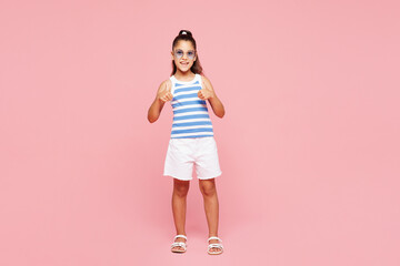 Traveler happy kid child wear blue casual clothes show thumb up isolated on plain pink background....