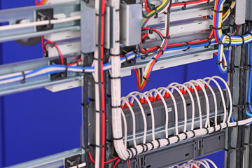 View from the back of the electrical panel. Connection of electronic modules using copper electrical wires. Fixed with plastic ties. 