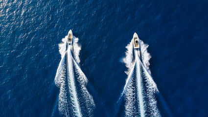 Two speed boats racing across the blue ocean
