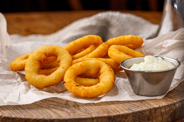 Golden Fried Onion Rings with Sauce in Metal Bowl