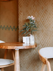 Cozy cafe interior with wooden table and decorative plant in a stylish setting