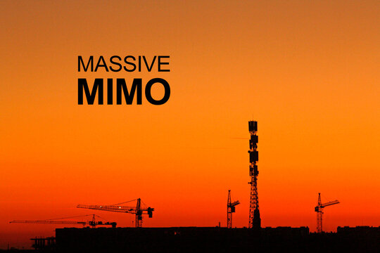 Image of 5G Massive MIMO Telecommunication tower at sunset. Cell Site Digital Cellular Telecommunication Tower Network Antenna and cranes on clear sunset orange sky background