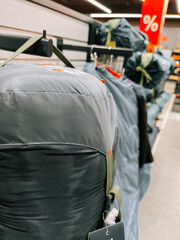 Camping gear on display in retail store highlighting promotions and savings for outdoor enthusiasts