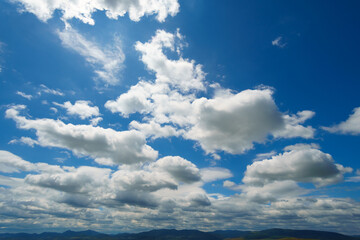 beautiful blue sky and bright white clouds, Carpathian mountains on background