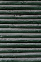 background of old weathered and cracked boards with peeling paint of green color