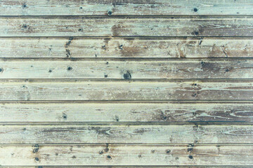 background of old weathered and cracked boards with peeling paint of brown color