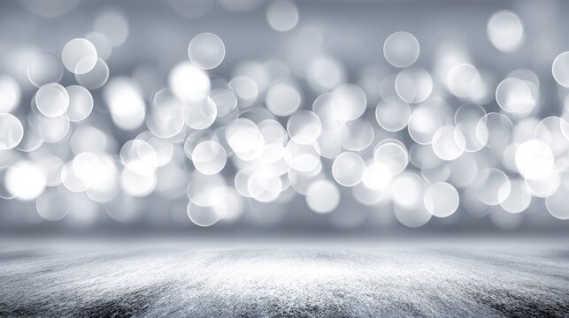 Soft, silvery bokeh lights against a gray background.