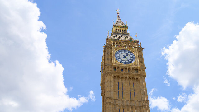 Big Ben and Elizabeth Tower in sunlight on blue sky background with copy space. Palace of Westminster in London, England