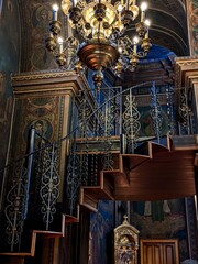 stairs on a blue-yellow-brown background with a painting on the background