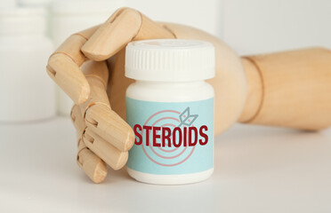 A bottle of Steroids is being held by a mannequin