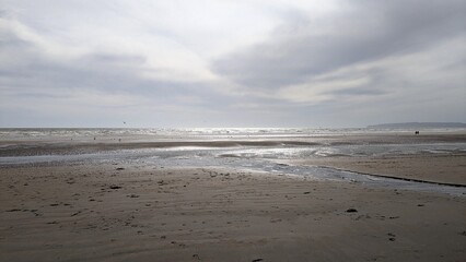 British sandy beach at low tide in the sun