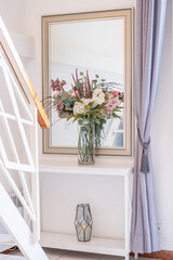 Elegant Interior Decor with Floral Arrangement and Mirror Reflection