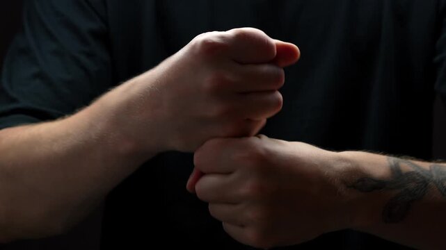 Choking gesture with hands on black background.
Evil and creepy hand gesture.
Man shows that he is ready to choke someone out of anger.
Choking and conflict