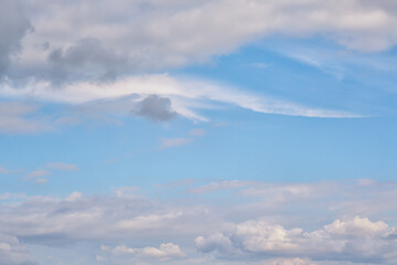 Light clouds in the sky in pastel tones close-up, white feathery clouds in the sky, calm colors of...