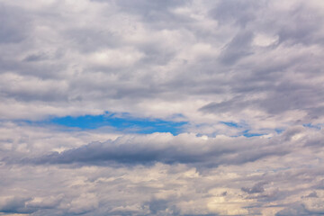 Large soft fluffy skylight clouds in the sky, mystical pink clouds moving across the sky, blurred background, soft focus.