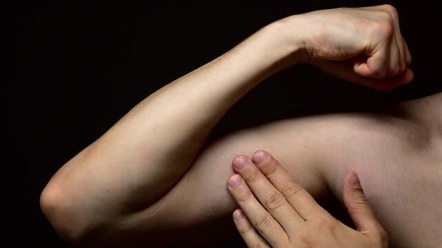 Biceps on a thin male arm on a black background.
Model shows muscles on her arms.
Pumped up arm of a muscular man on a dark background.
Muscles, sports, biceps, athletics