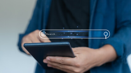 Close-up of hands using a tablet with an AI search bar interface, representing artificial...