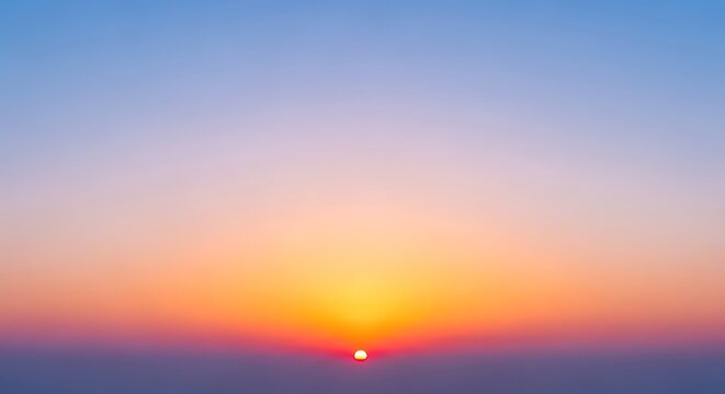 A vibrant sunset with a gradient sky transitioning from blue to orange and a visible sun disk at horizon