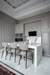  Elegant kitchen featuring a marble island with seating, grey cabinets, and ornate ceiling.