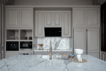 Modern luxury kitchen with marble island, grey cabinets, and high-end appliances, perfect for...