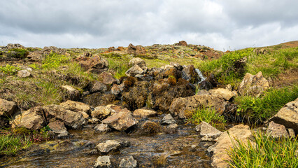 mountain landscape with smaal river and clouds
