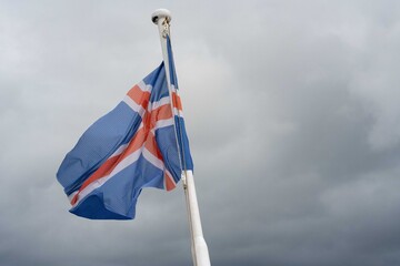 Iceland flag against cloudy sky