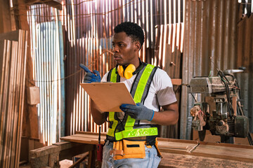 Factory Worker African American Man Supervisor Using Checklist to Inspect Timber Stock in Sawmill...