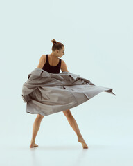 Fashionable dancer spinning in oversized coat mid-turn with playful confident motion. Concept of...