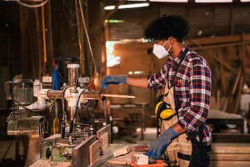 Young African American Carpenter Wearing Dust Mask And Gloves Working With Tools On Woodworking...