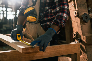 Factory Worker Measuring Timber Plank in Wood Sawmill, African American Man Preparing Wood for...
