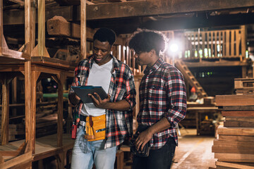 Factory Workers Discussing Work in Timber Sawmill, Two African American Men Collaborating in...