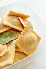 Delicious Homemade Ravioli Ready for Cooking with Bay Leaves and Unique Filling Perfect for Any Family Dinner or Special Occasion.