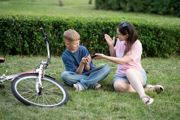 Mother tries to take away her son's smartphone. Teenagers suffer from gadget addiction