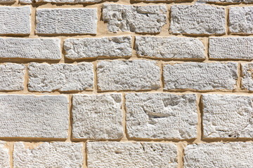 Textured stone wall featuring irregular shapes and shades, showcasing natural materials and...