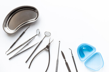 Dental equipment tools for teeth care on white background. Professional Dentist desktop, top view