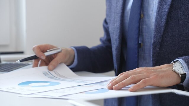 Professional analyzing financial charts on laptop, reviewing data for strategic business planning and investment optimization. Business people concept