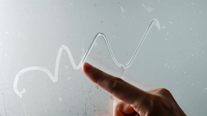 Hand tracing shapes on frosty glass with realistic soft motion